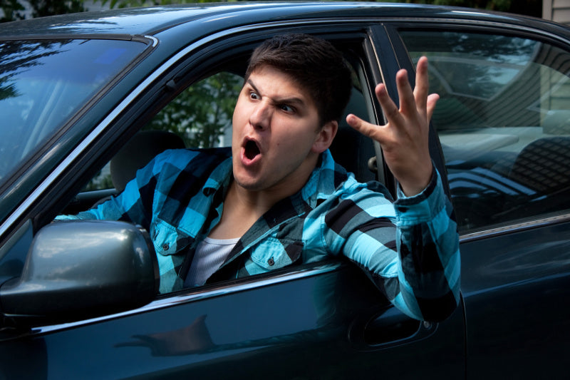wściekły kierowca wymachuje przez okno samochodu